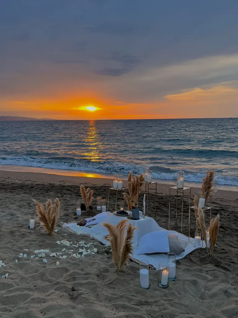 Barceloneta Beach marriage proposal setup showing luxury picnic pillows and candles on the sand, photo 1
