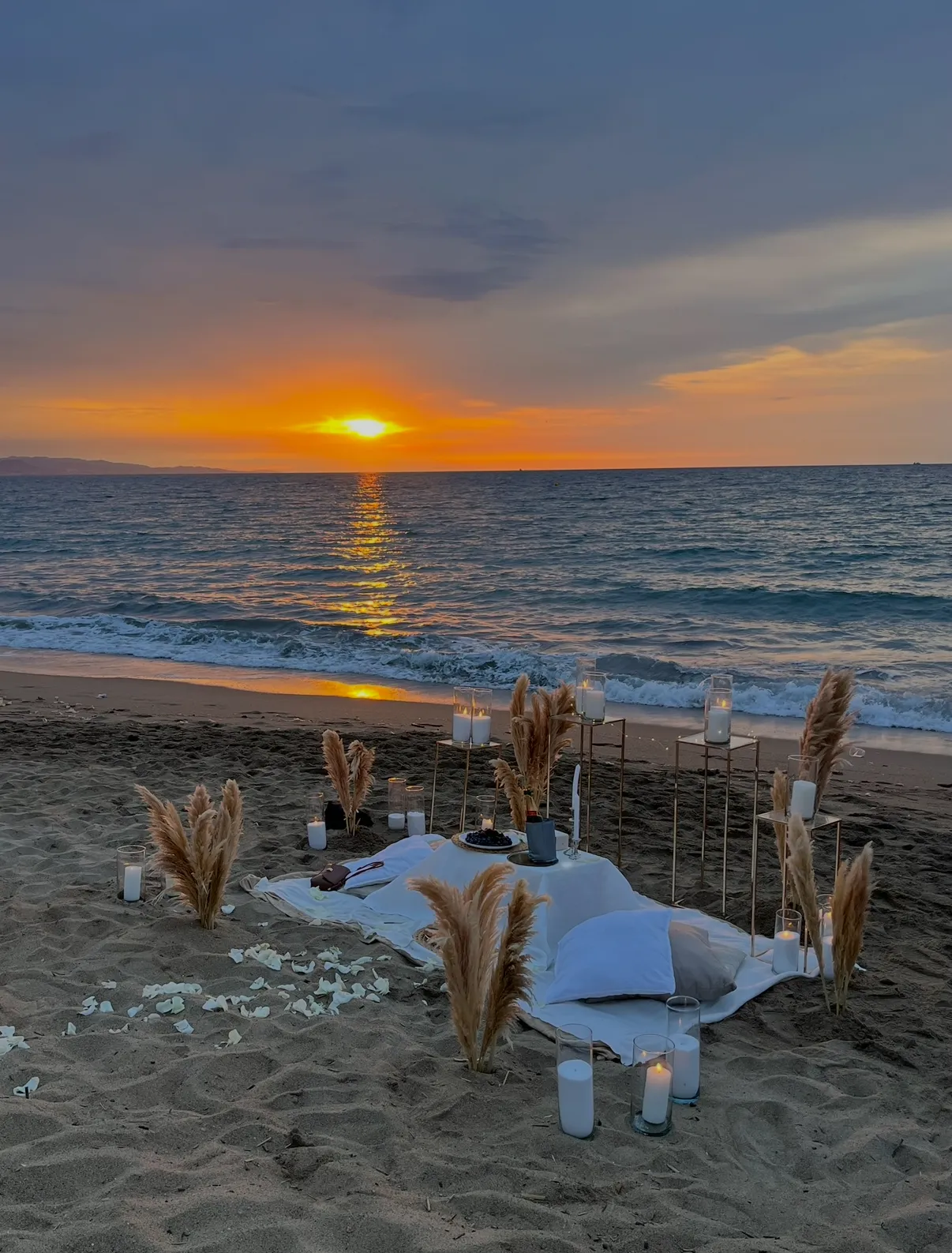 Barceloneta Beach marriage proposal setup showing luxury picnic pillows and candles on the sand, photo 1
