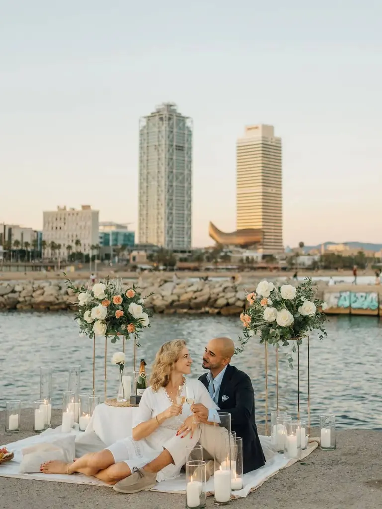 Barceloneta Beach marriage proposal setup showing luxury picnic pillows and candles on the sand, photo 7