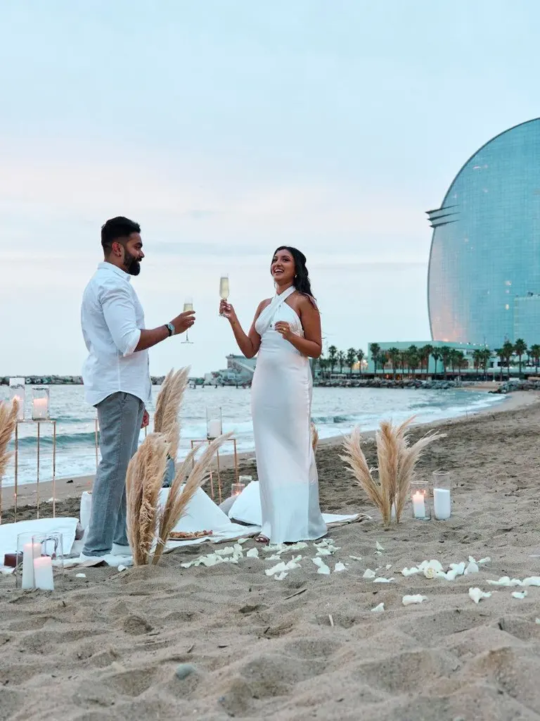 Barceloneta Beach marriage proposal setup showing luxury picnic pillows and candles on the sand, photo 9