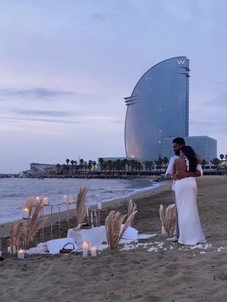 Barceloneta Beach marriage proposal setup showing luxury picnic pillows and candles on the sand, photo 10