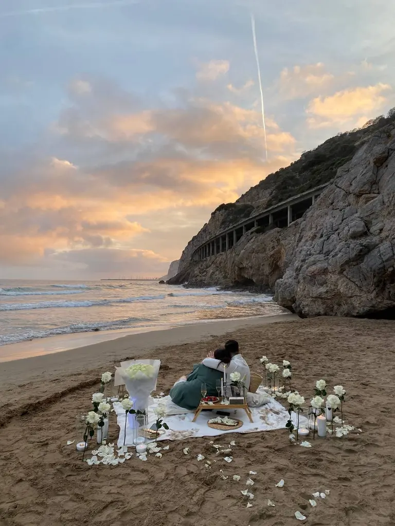Ginesta beach marriage proposal setup with white roses and cliffs 9
