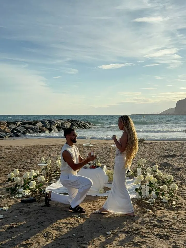 Ginesta beach marriage proposal setup with white roses and cliffs 12