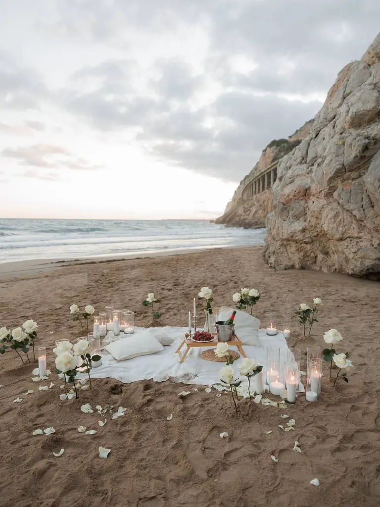 Ginesta beach marriage proposal setup with white roses and cliffs 6