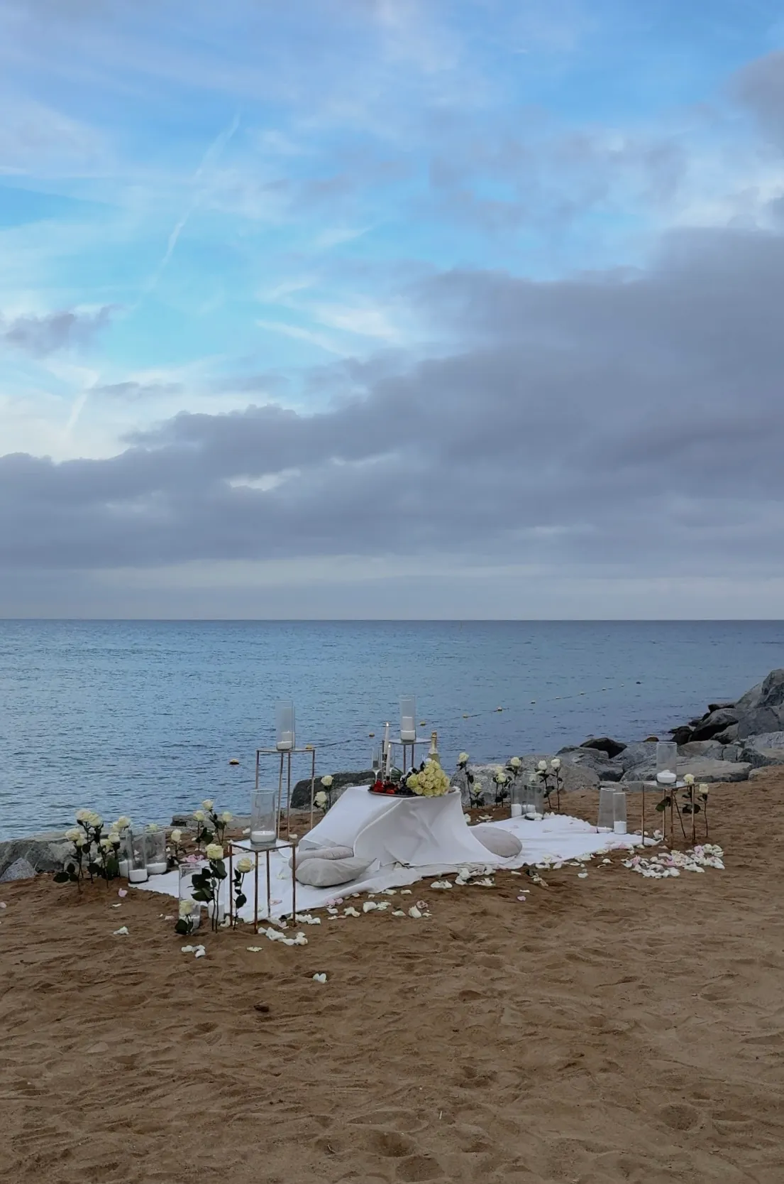 Nova Mar Bella beach proposal setup in Barcelona showing picnic decor - view 1