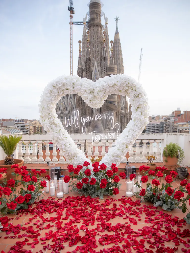 Sagrada Familia rooftop proposal setup in Barcelona showing floral arch and view 9