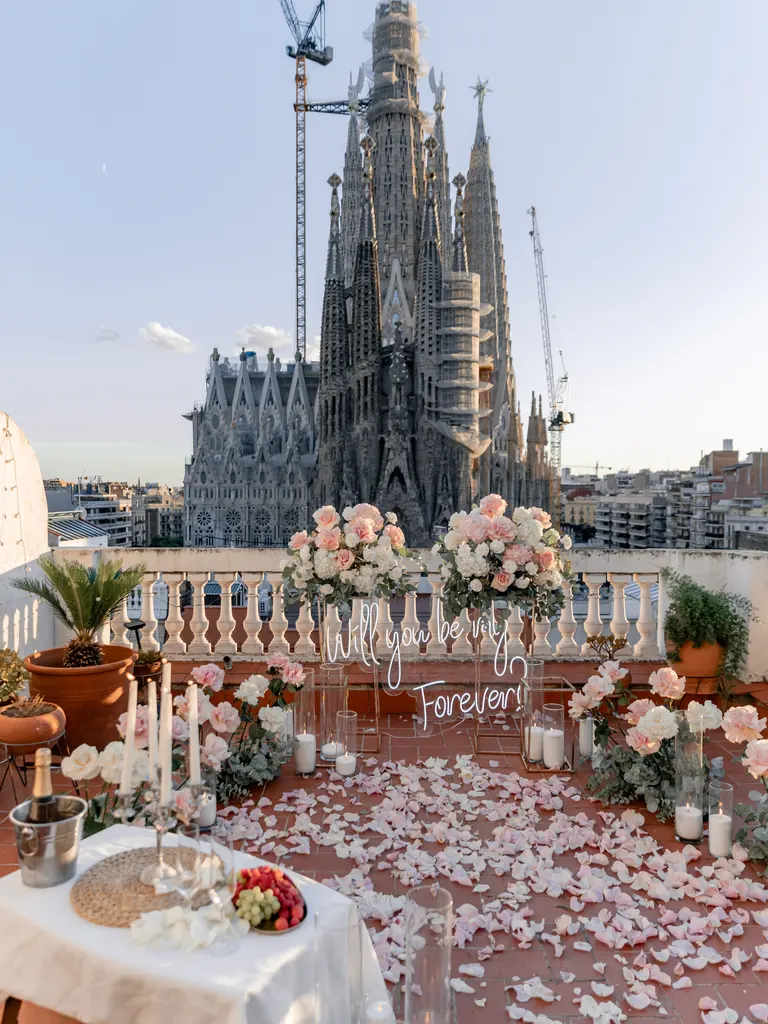 Sagrada Familia rooftop proposal setup in Barcelona showing floral arch and view 11