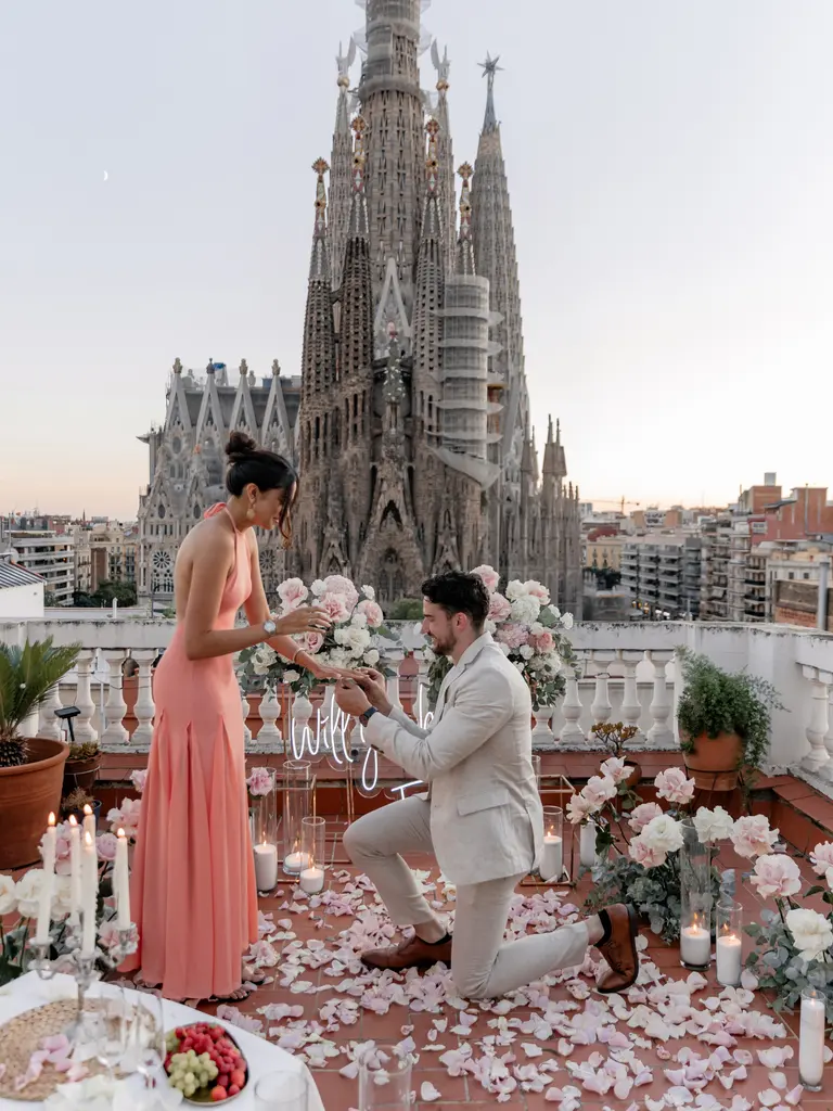 Sagrada Familia rooftop proposal setup in Barcelona showing floral arch and view 12