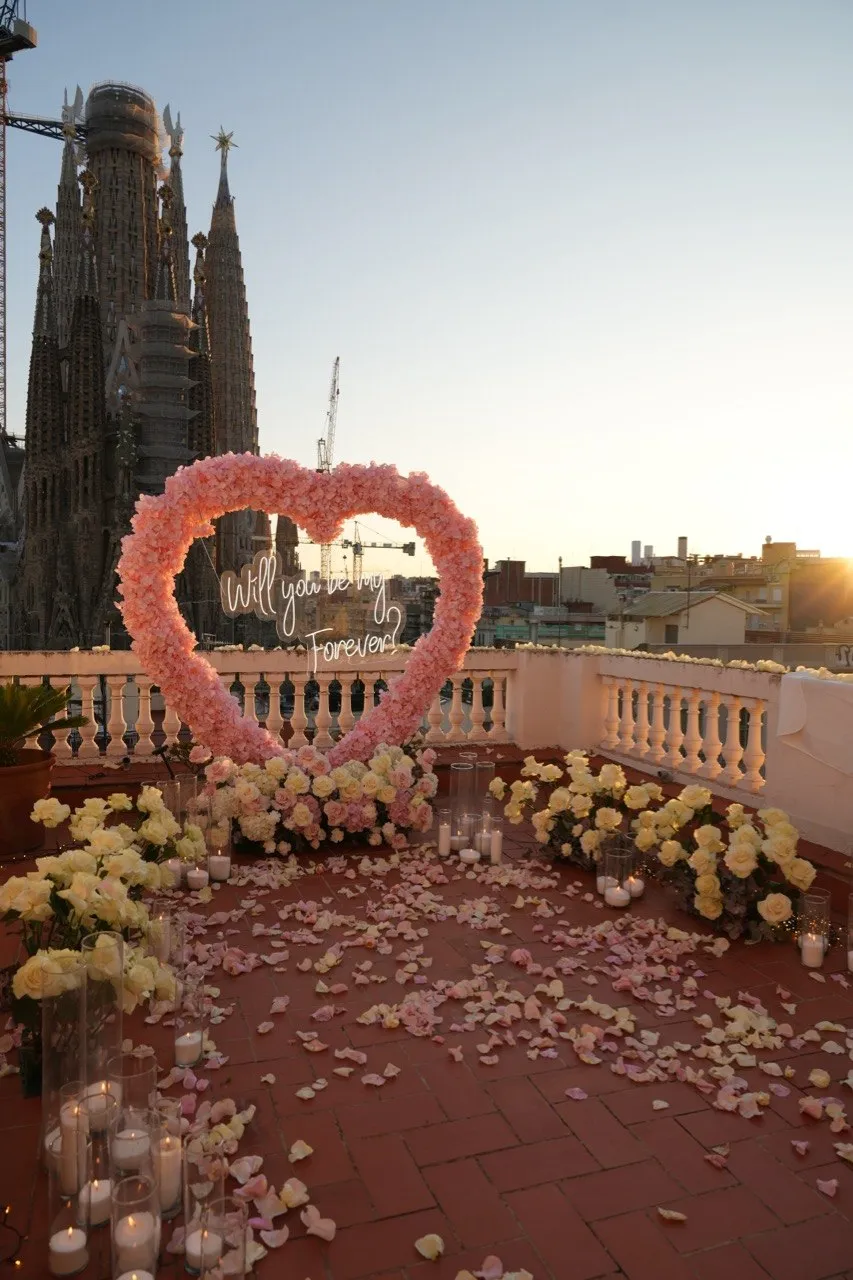 Sagrada Familia rooftop proposal setup in Barcelona showing floral arch and view 1